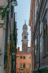 Obraz premium old street in Venice in the background it can be seen a beautiful church tower 
