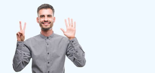 Young hipster man showing and pointing up with fingers number seven while smiling confident and happy.