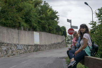 Mother,daughter and auntie being happy on a side road in Belluno italy 
