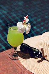 Fresh guava juice smoothie drink with straw hat , flower and sunglasses