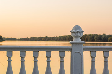 Waterfront district white architecture fence background facade frame near river in evening sunset...