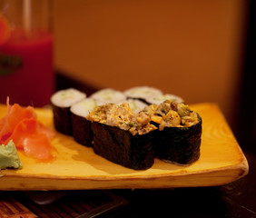 served maki rolls on wooden plate 