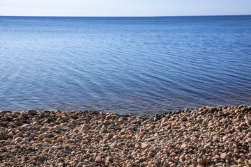 stones, blue water and sky. calmness and silence. skyline