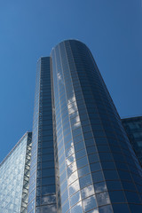 Fototapeta na wymiar blue glass building with a reflection of the sky