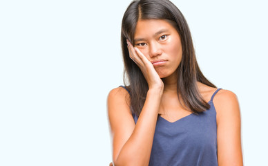 Young asian woman over isolated background thinking looking tired and bored with depression problems with crossed arms.