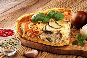 Homemade Cheesy Egg Quiche for Brunch with Spinach and Tomato, onions and zucchini.