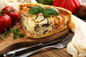 Homemade Cheesy Egg Quiche for Brunch with Spinach and Tomato, onions and zucchini.