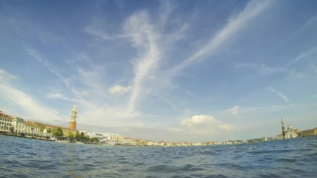 Sunny day skyline with boat traffic on San Marco basin in Venice, Italy. San Marcos bell tower, Doges palace at left and San Giorgio Maggiore church at right. Time-lapse view from Punta della dogana.