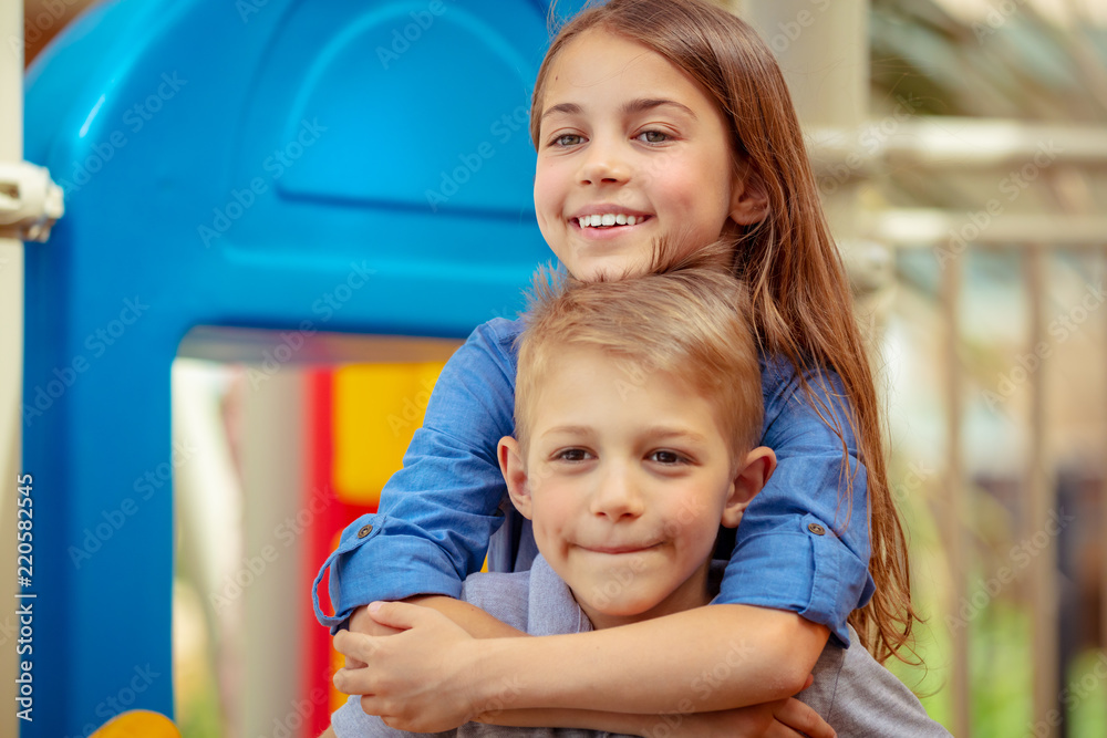 Wall mural happy siblings outdoors