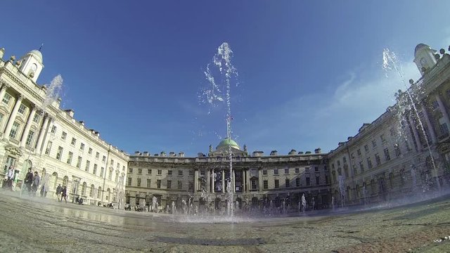 Footage view of spurting water fountains by Somerset House in London, UK on a sunny day. Ultra wide angle view. 