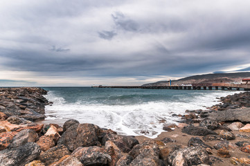 Fototapeta na wymiar Beach landscape and rocks with cloudy sky