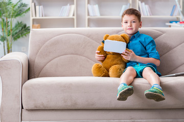 Young little boy with VR virtual reality glasses