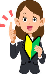 初心者マークを手に持ち説明するスーツを着た女性
