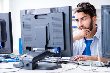 IT technician looking at IT equipment