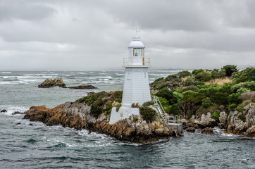 Hells Gate Lighthouse at the mouth of Macquarie Harbour on the west coast of Tasmania, Australia. 