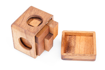 A wooden puzzle is a cube. Isolated on white background. Close-up.