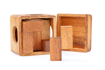 A wooden puzzle is a cube. Isolated on white background. Close-up.