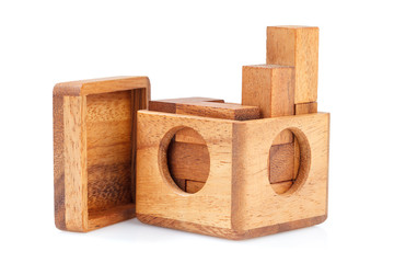 A wooden puzzle is a cube. Isolated on white background. Close-up.