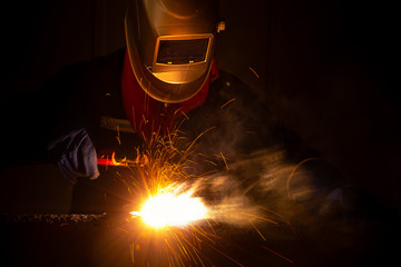 Worker welding in manufacturing.