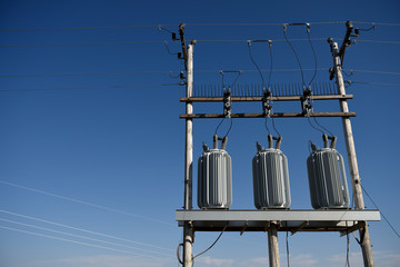 Rural country electrical grid, transformers, blue sky, Wyoming, copy space
