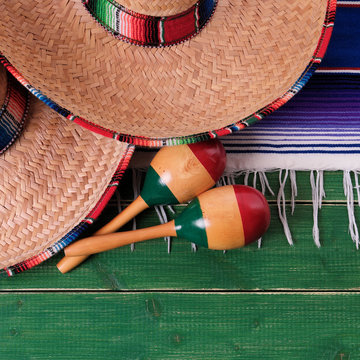 Mexico cinco de mayo fiesta carnival traditional green wood background border mexican sombrero maracas serape rug or blanket photo square format