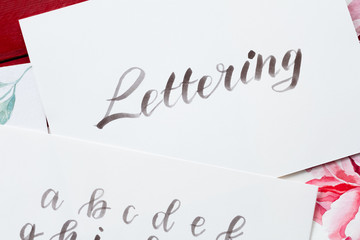 watercolor brush lettering. artful hobby and creative handwriting. word written on white paper.