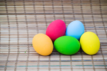 Colorful Easter eggs background. holiday, easter background. Colorful easter eggs on the green garden yard. symbol of easter's day festival. vivid color natural background. festive wallpaper.