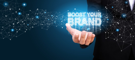 Boost Your Brand in the hand of business. Boost Your Brand concept
