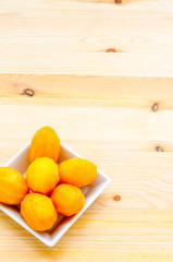 Sweet Marian plum, thai fruit isolated on wooden background, Sweet fruit of Thailand