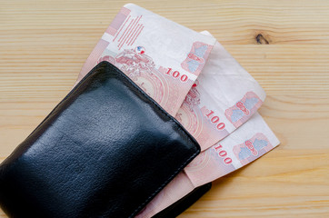 Old black wallet and three hundred bath