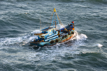 Fishing boat in a stormy sea