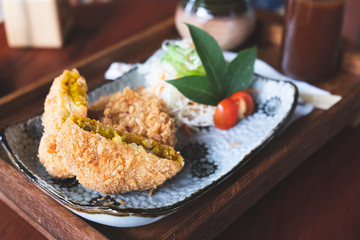 Croquette cut half and  vegetable on table