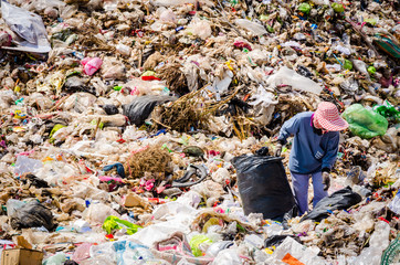 MUKDAHAN PROVINCE, THAILAND-FEBRUARY 29: People working in Municipal waste disposal open dump process.  Dump site at Mukdahan Province on FEBRUARY 29 , 2016 in MUKDAHAN PROVINCE THAILAND