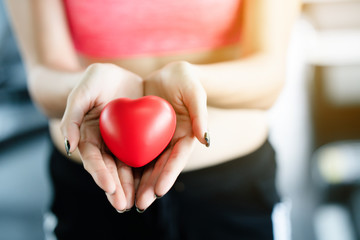 Close up of a red heart on a woman hand. It shows a love that is full of happiness. Exercise makes the heart And strong body. To bring love together is a good thing to the whole world.