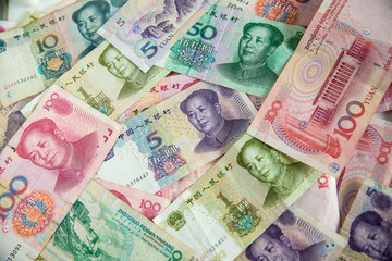 Obraz premium Many yuan currency banknote wallpaper. image for background, wallpaper,illustration, article and copy space. saving and investment concept. great power of asia and world economy.