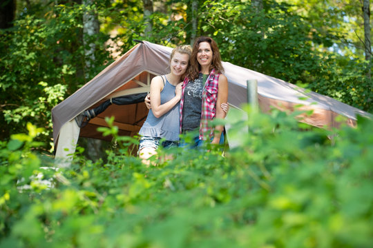 Happy mother and daughter camping in nature - Powered by Adobe