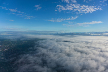 View of blue sky with cloud and city scape in plane window seen.