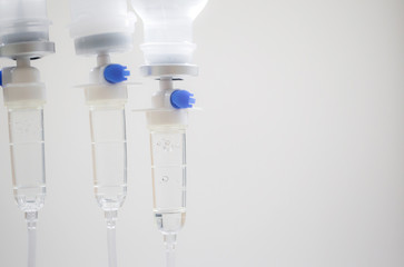 Close up saline bottle and saline drop with blur background. Illness treatment. Health insurance plan. Medical Benefits. Reimbursement. Medical expenses. image for illustration, copy space, article.