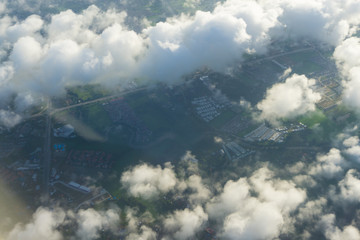 View of blue sky with cloud and city scape in plane window seen.