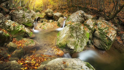 Autumn landscape waterfall river into canyon.