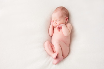 Funny newborn baby sleeping peacefully naked. Top view © irena_geo