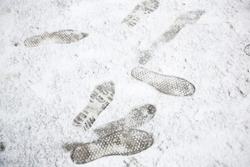 Shoeprints,footprints,bootprintd on ground coved by white snow.be careful to walking on the snow.