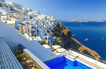 Pool and a view sunny morning view of Santorini island. Picturesque spring scene of the famous Greek resort Thira, Greece, Europe. Traveling concept background.
