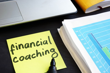 Memo stick with words financial coaching. Education concept.