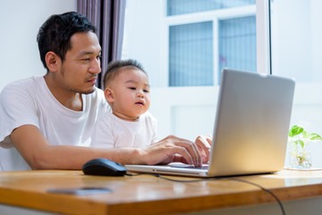 Man father using working on laptop computer