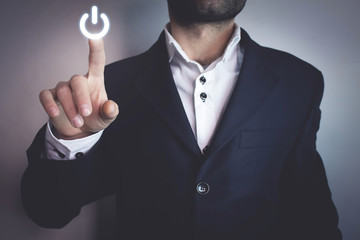 Man pressing power button.