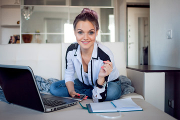 Beautiful girl working at home with laptop