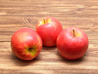  Pink Lady apples isolated on wooden background