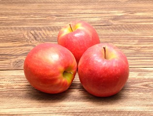  Pink Lady apples isolated on wooden background