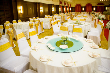 wedding table sets in wedding hall. wedding decorate preparation. table set and another catered event dinner, luxury wedding table setting for fine dining at outdoors.